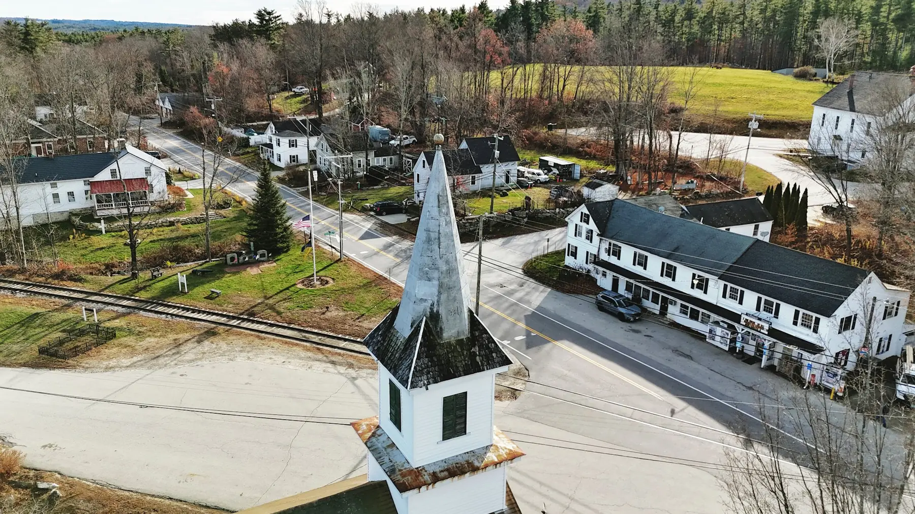 A small New England town seen from above, church steeple at its centre